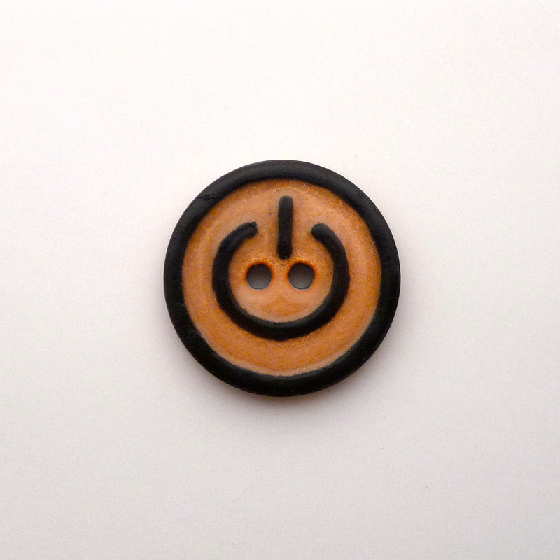 Power Button: an enamel button made for The Button Project